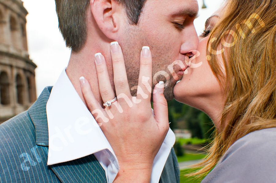 Kissing during engagement session with ring close up 