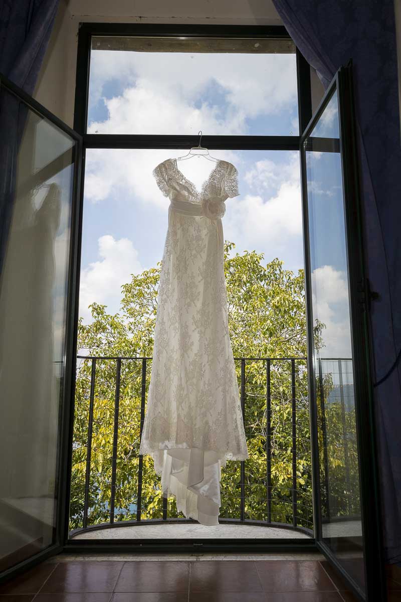 Wedding dress hanging from the window.