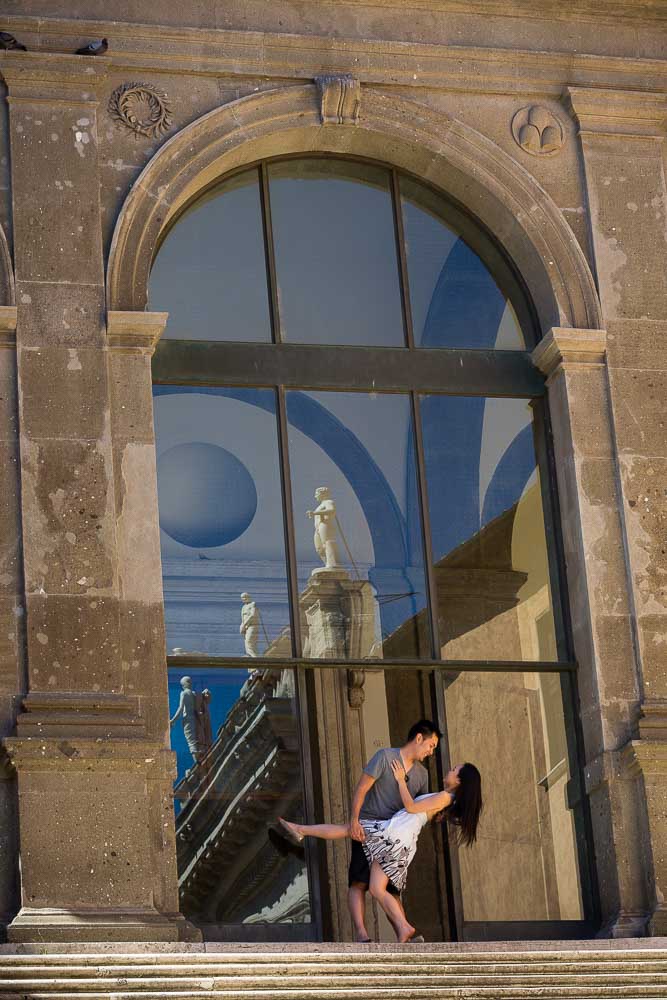 Photography of man and woman posing on top of the stairs found in Piazza del Campidoglio.