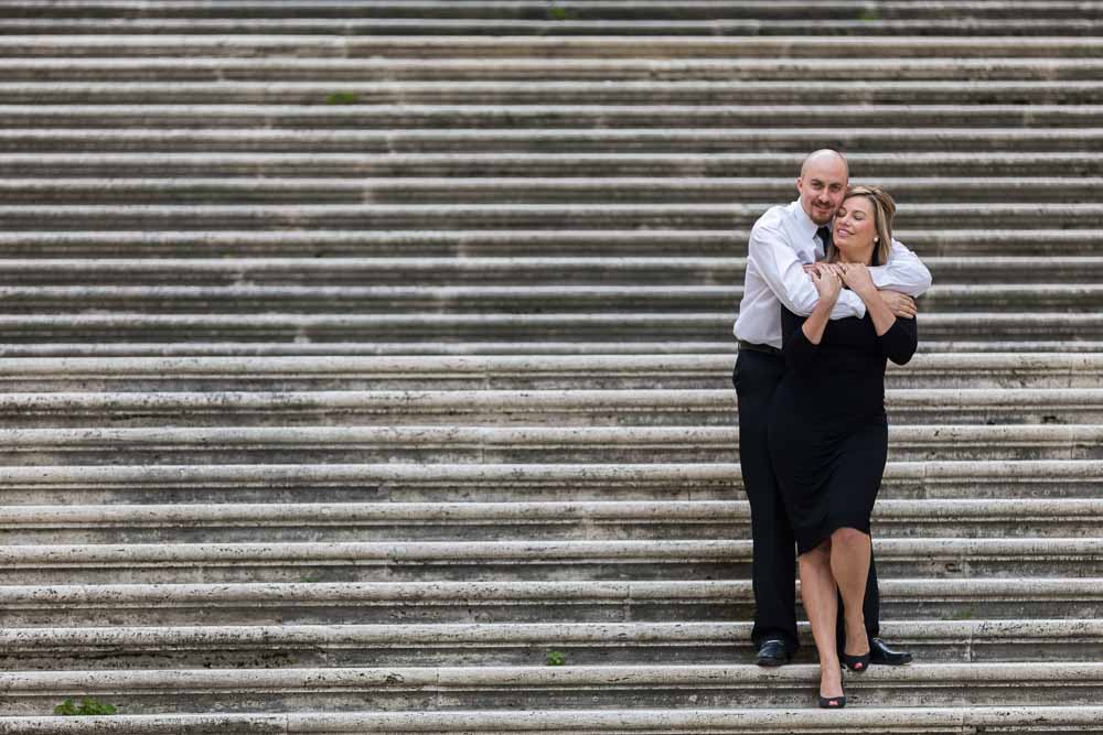 Couple happily posing together on a large staircase