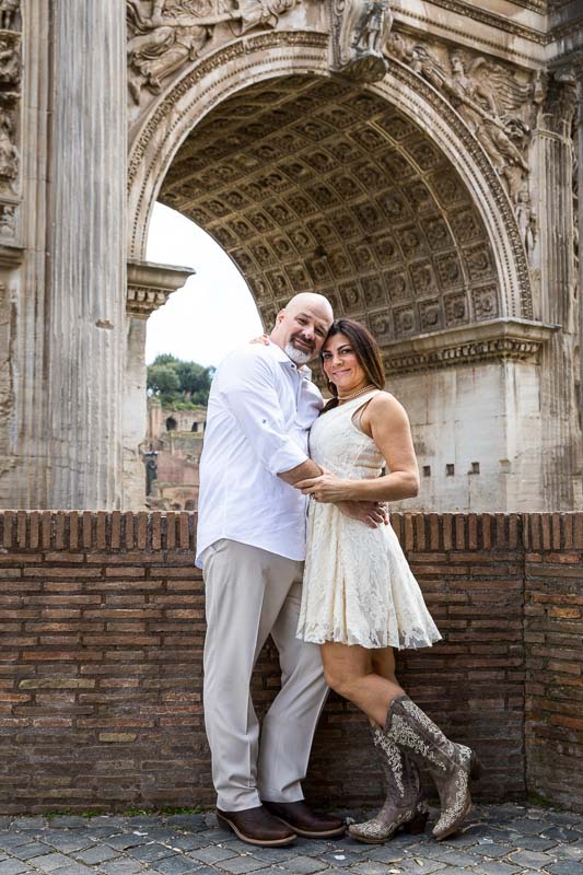 Portrait picture standing close to one another under an ancient roman arch