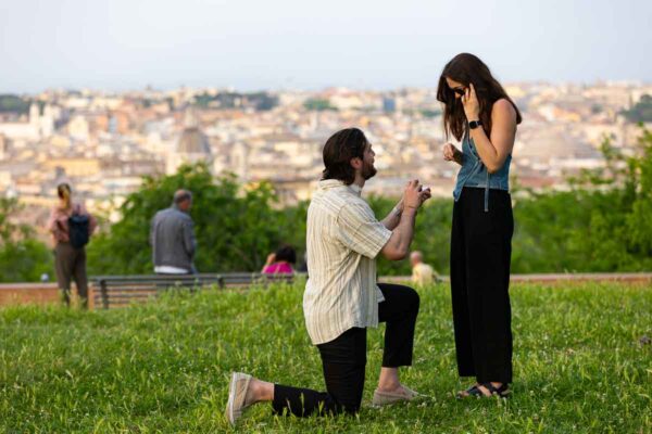 Janiculum terrace proposal actually proposing on soft green grass overlooking the Rome city from above