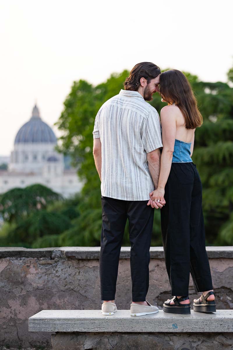 Posed portrait picture taken by a photographer in front of Rome Saint Peter's Basilica in the far distance right after a Janiculum Terrace proposal