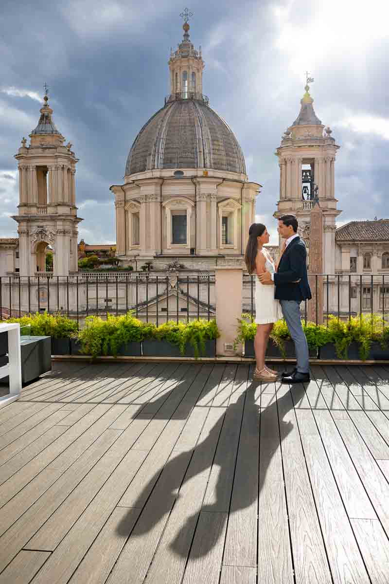 Vertical portrait of a couple during an engagement photo session on scenic terrace at sunset 