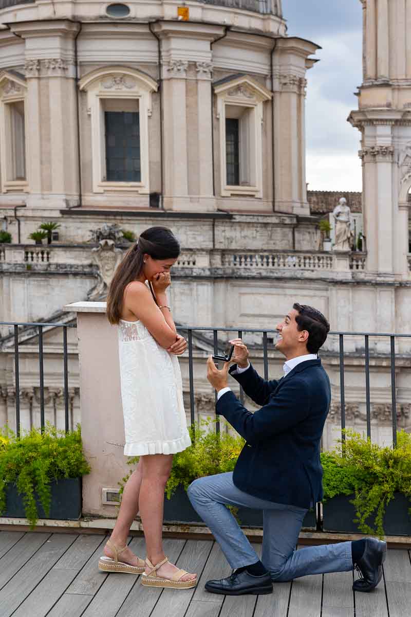 Kneeling down for a Terrace proposal in Rome candidly photographed from afar during a photoshoot