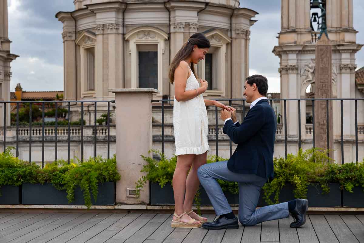 Close up of the proposal moment in which the ring is put on, on a terrace in Rome