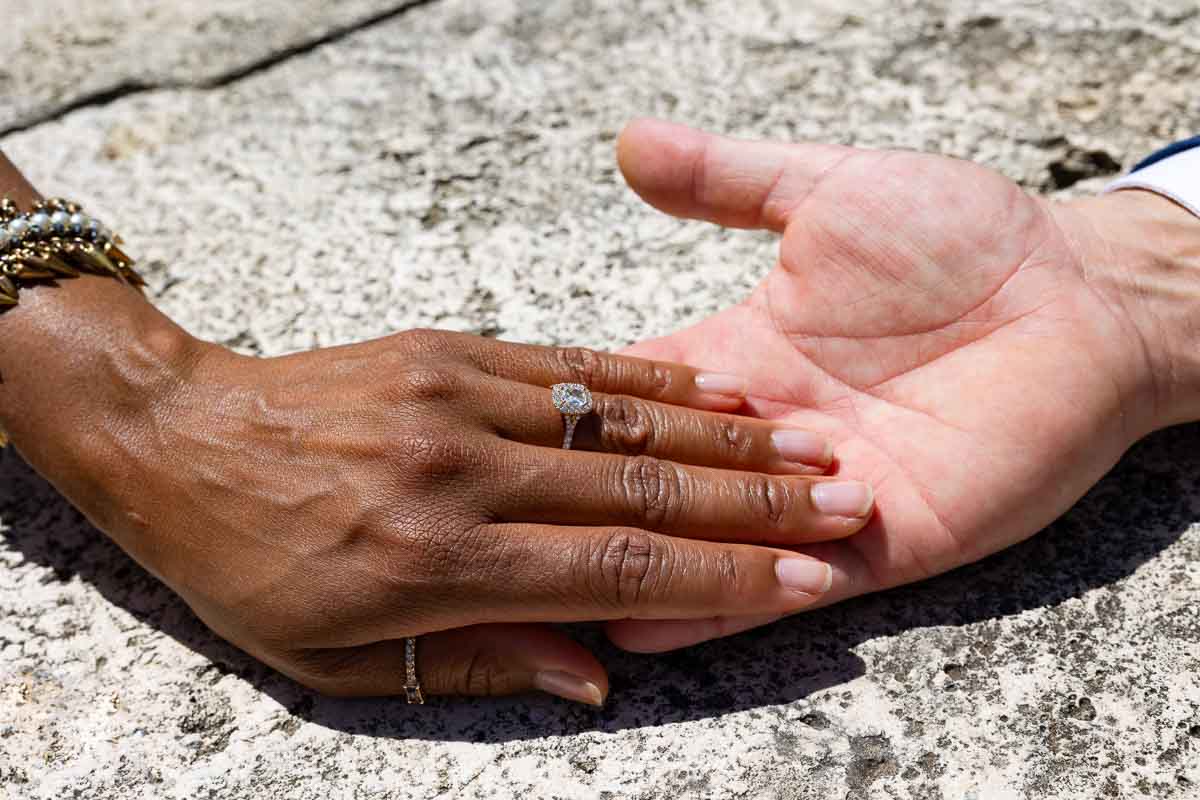 Engagement ring photography one hand holding the other showing the beautiful ring 