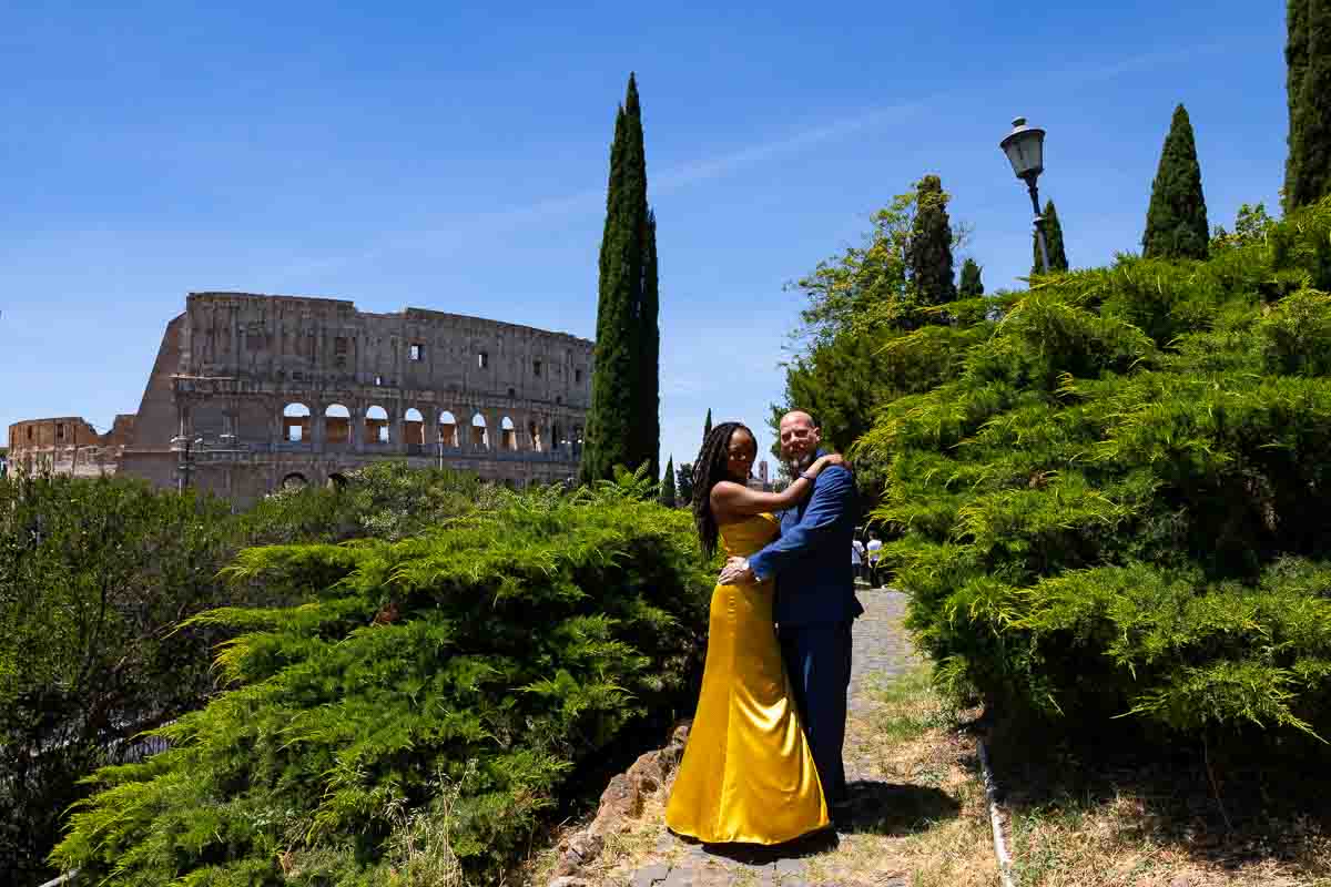 Couple posing together in formal attire with a nice bright yellow dress 