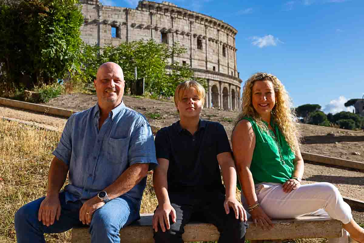 Close up family portrait picture with the Italian Roman Coliseum as backdrop 