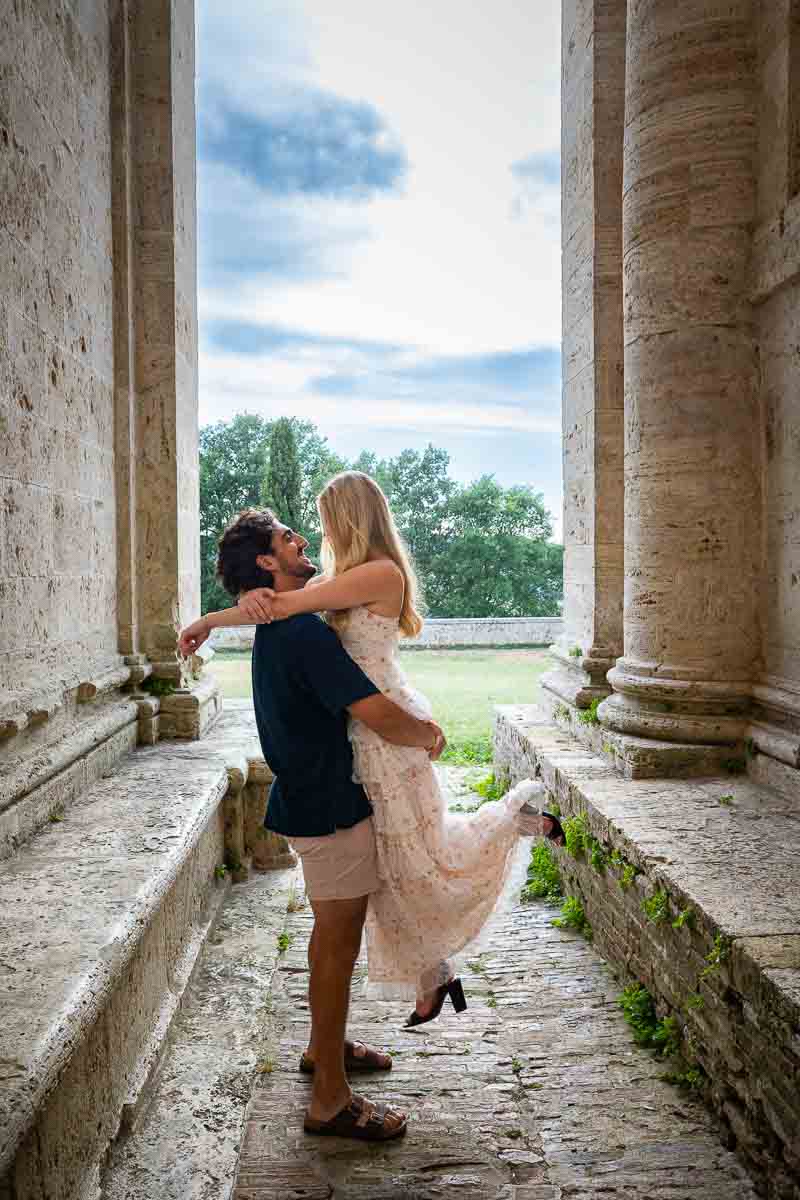 Picking up his fiancee to take engagement pictures in between the columns of the Temple of San Biagio (Montepulciano) Italy 