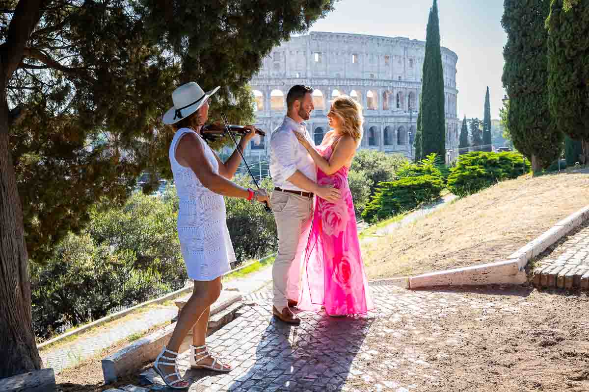 Romantic engagement in the shadow of the Coliseum to gentle violin music. Rome Coliseum Proposal 