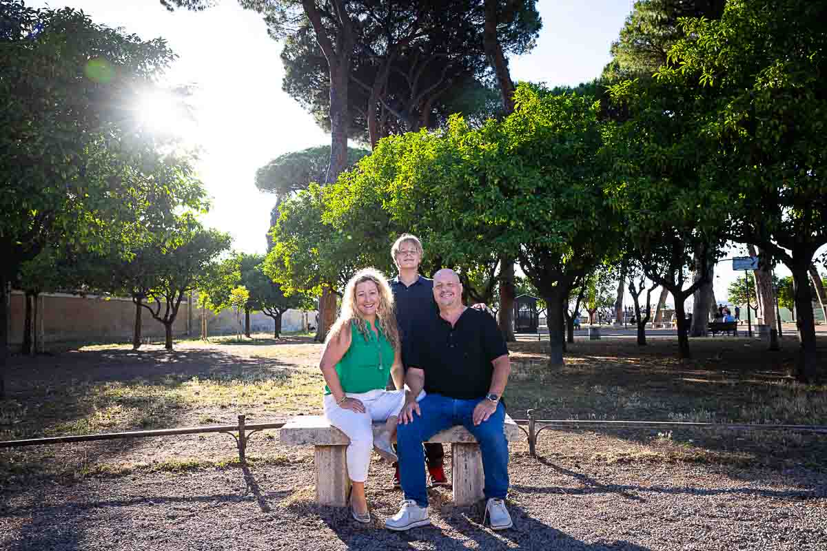 Sitting down group photo on a stone bench among the giardino degli aranci orange trees 