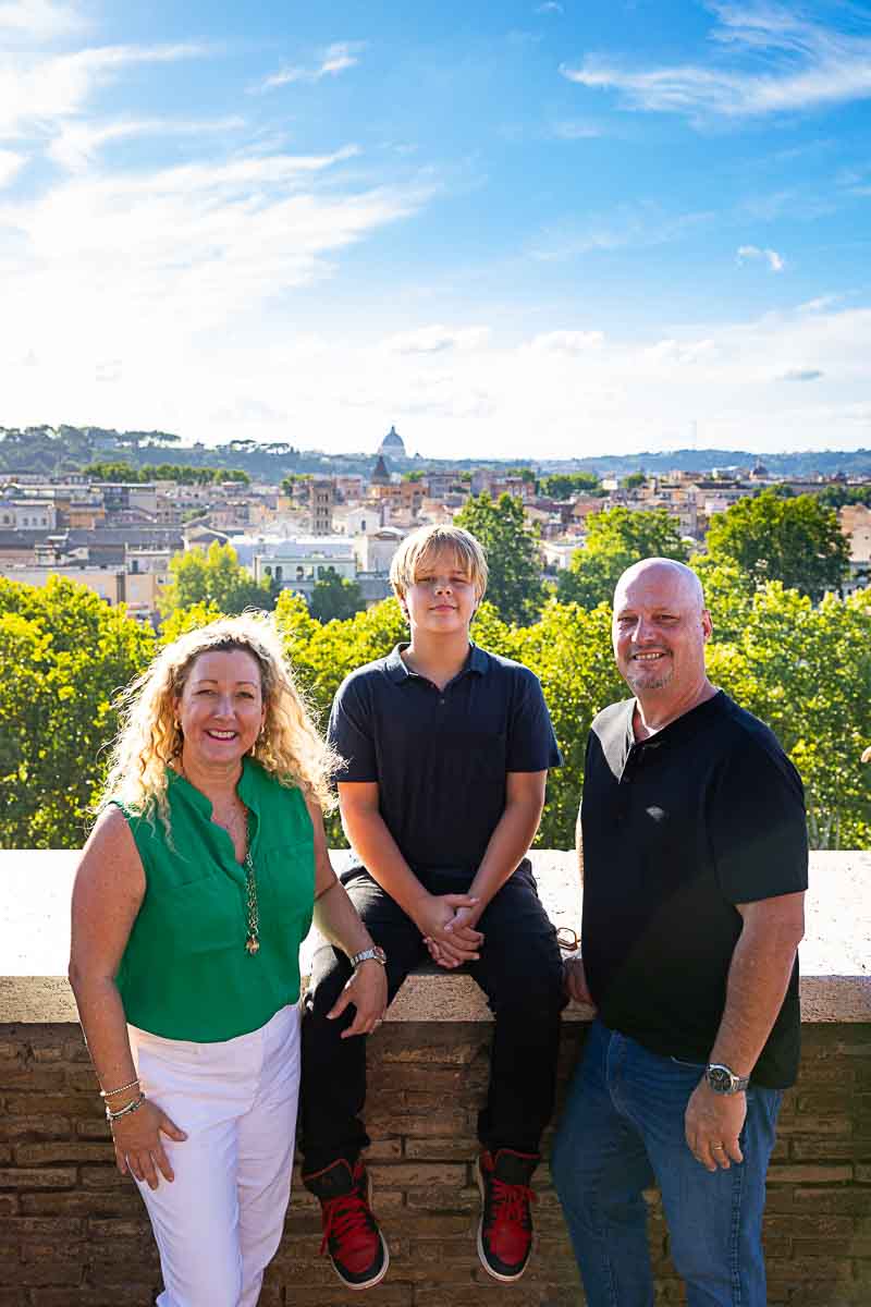 Posed for a family portrait picture in front of the Rome skyline 