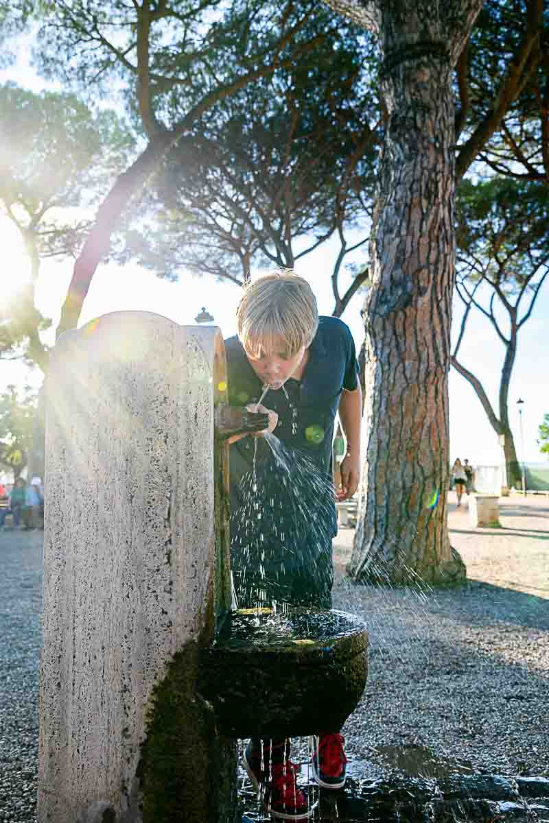 Drinking from a water fountain on a summer day 