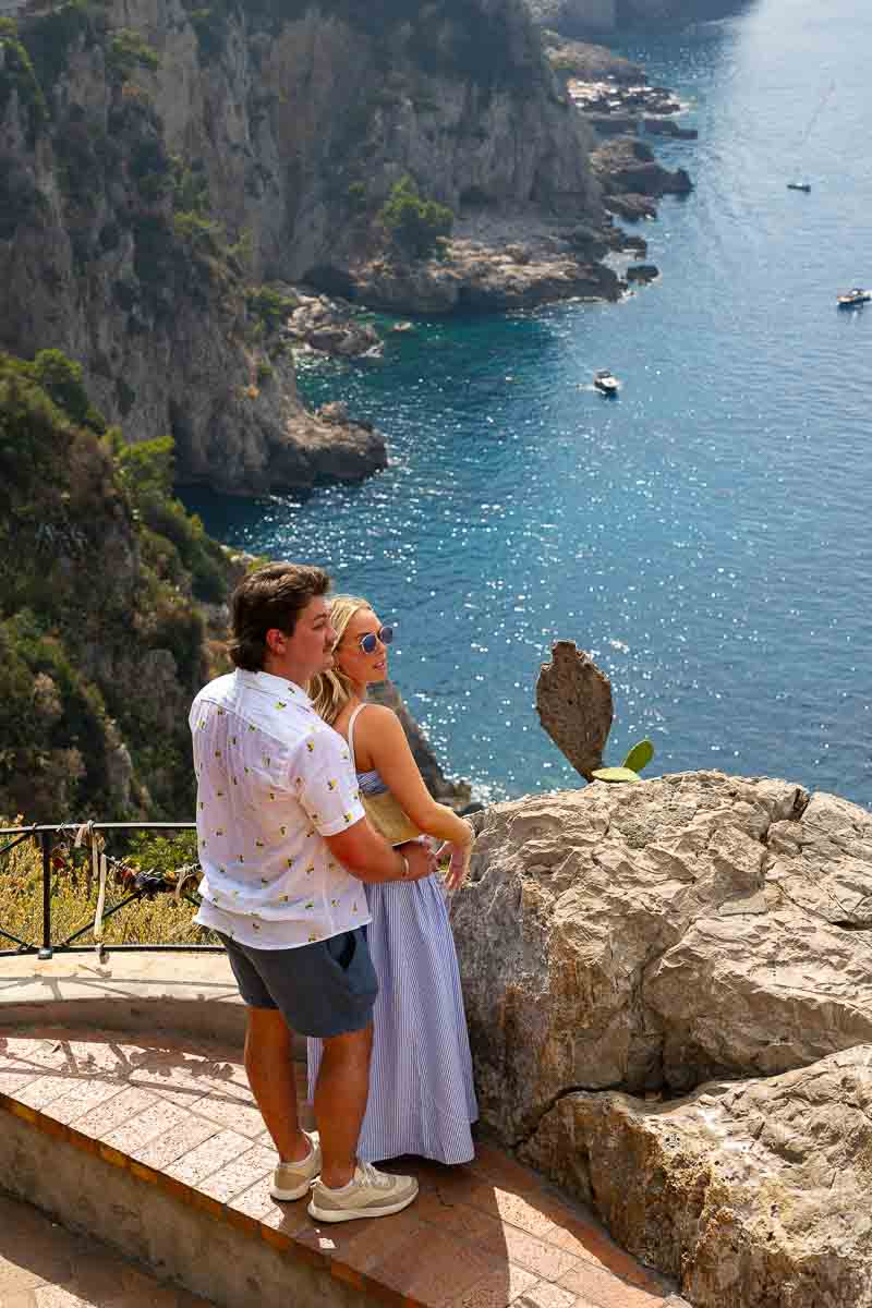 Just engaged couple looking at the Capri island 