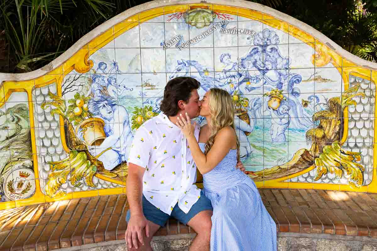 Kissing in front of a ceramic bench 