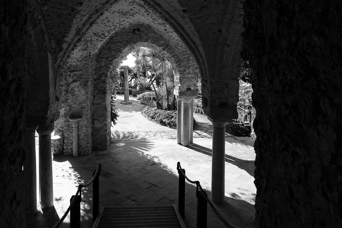 The columns and colonnade of the interior courtyard of Villa rufolo in black and white photography 