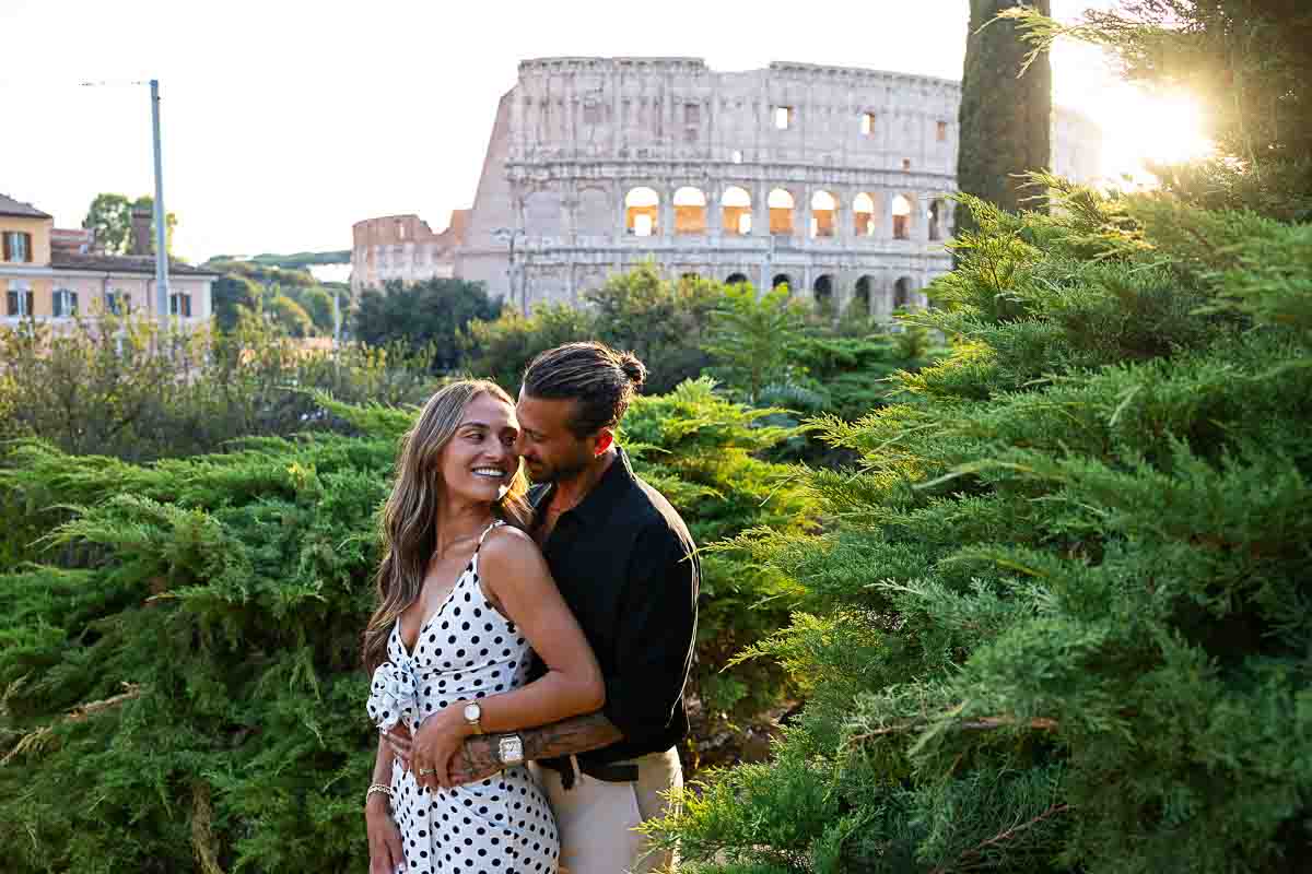 Couple posing at the Colosseum at sunset 