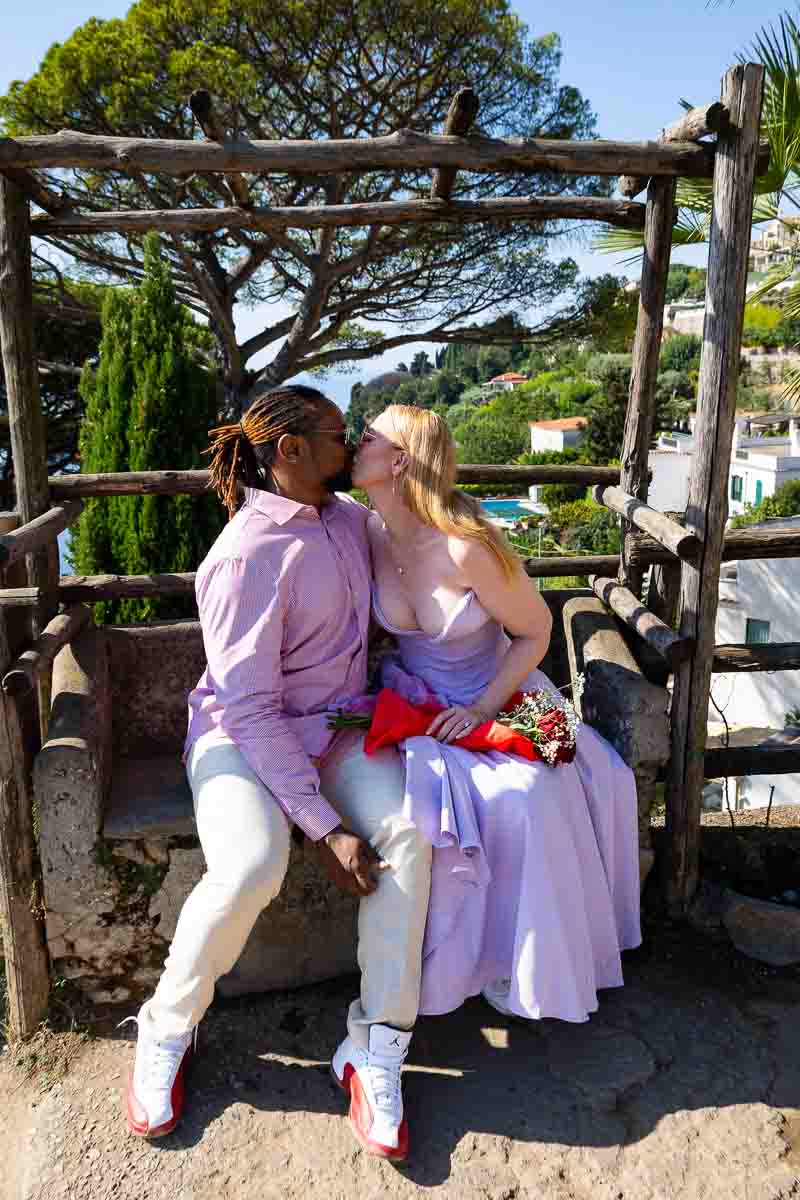 Just engaged in Italy couple kissing on a bench 