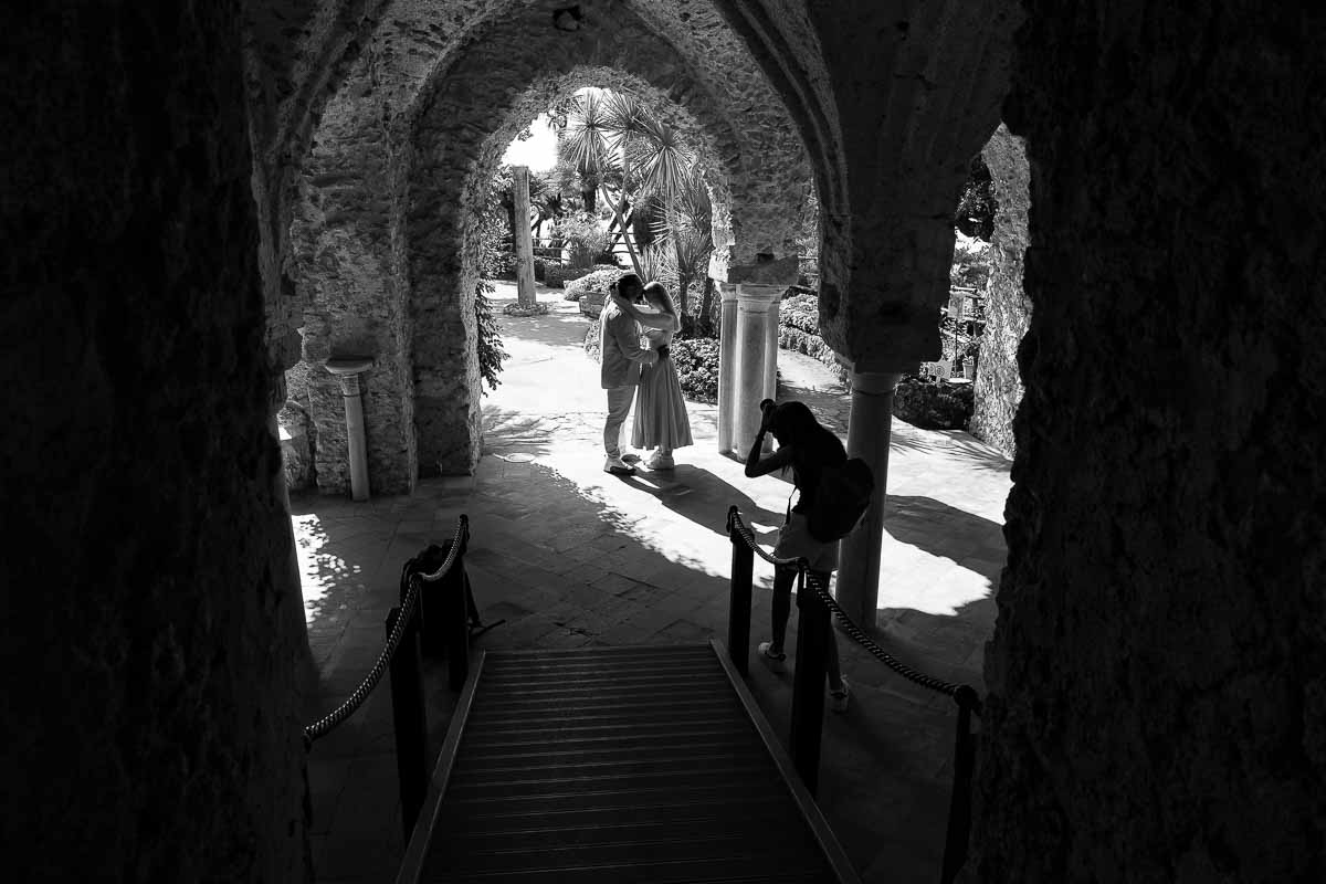 Photographer taking picture of a couple during a Ravello Proposal photography session in black and white 