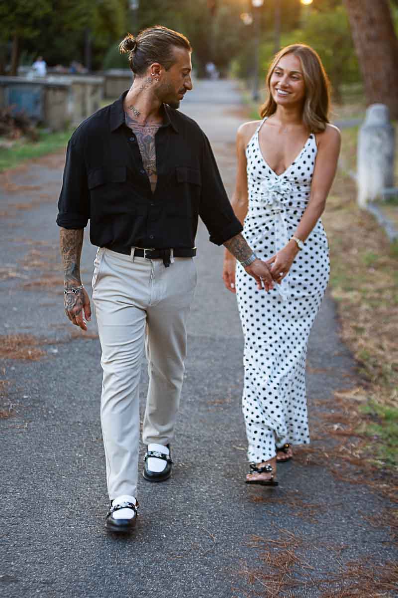 Walking hand in hand in a park at dusk 