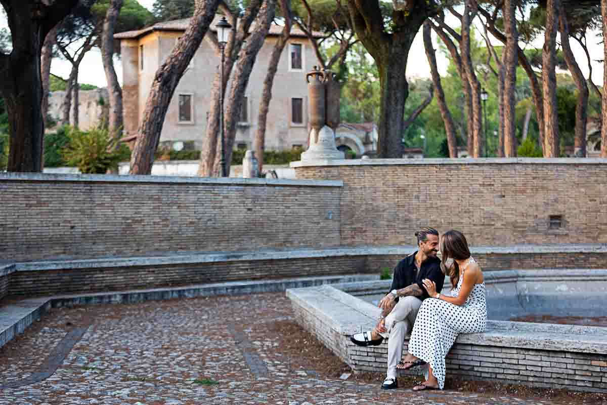 Sitting down by a water fountain in Rome Italy during a lifestyle photoshoot 