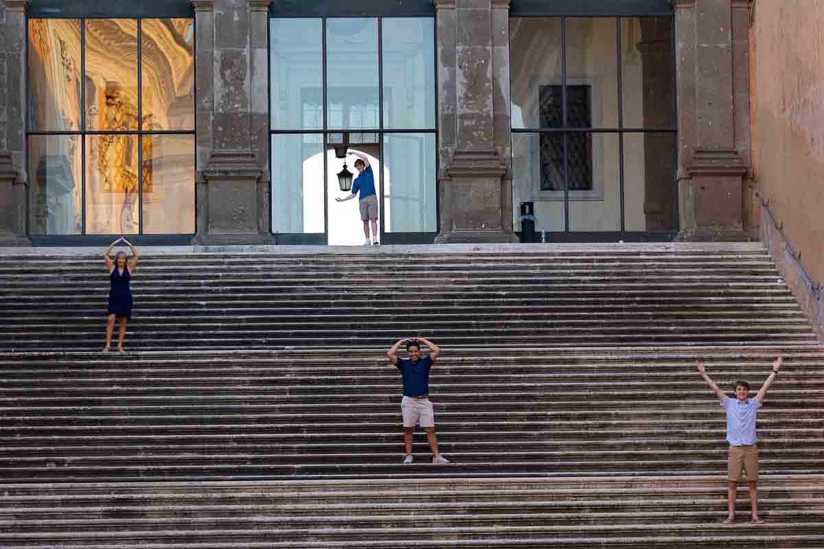 Family photos standing on a large staircase