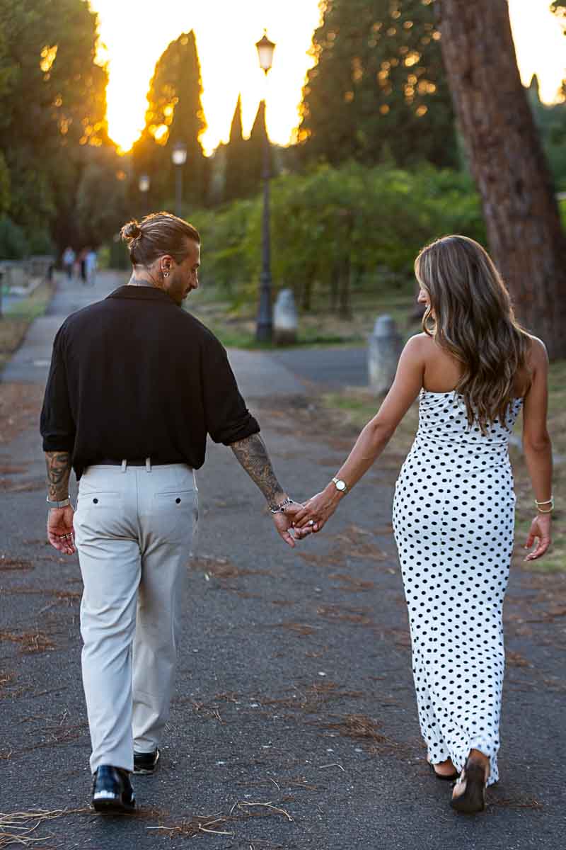 Walking away hand in hand at the end of the photography session in the Eternal city 