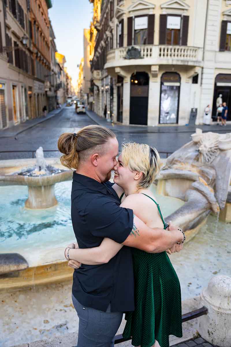 In Love in Rome during an engagement photoshoot by the Barcaccia water fountain found at the bottom of the spanish steps 