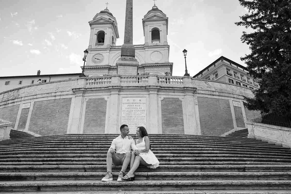 Couple sitting down on the spanish steps without anyone around 