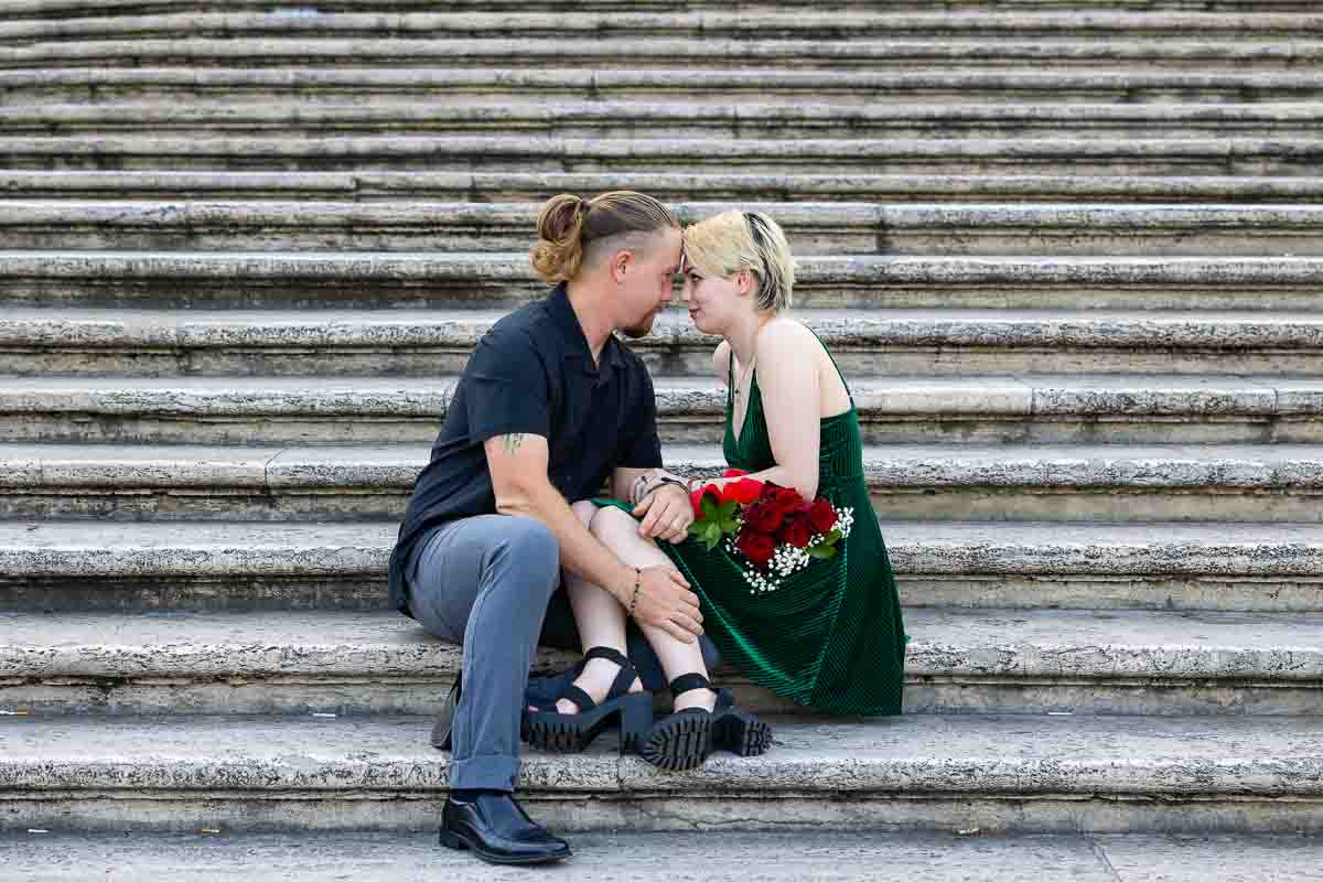 Close up couple sitting down on the steps of Piazza di Spagna 