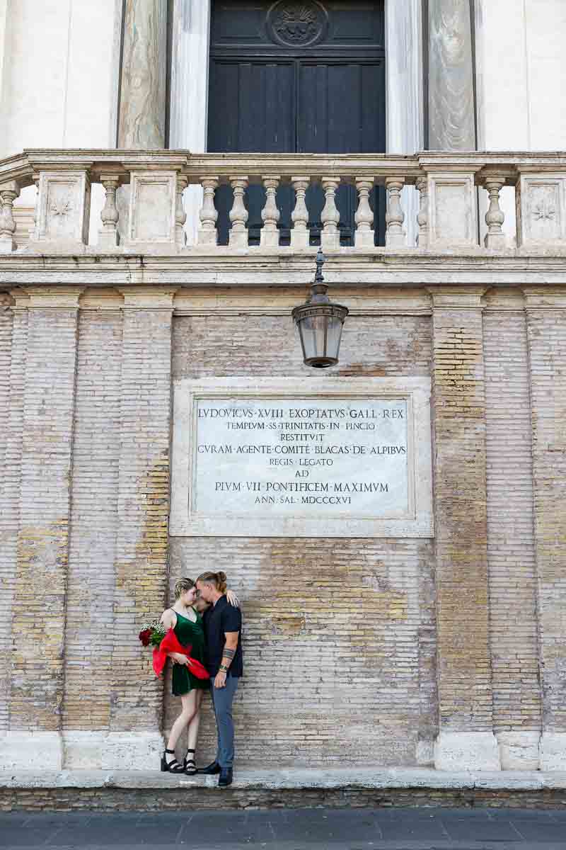 Couple standing underneath the church Trinita' dei Monti 