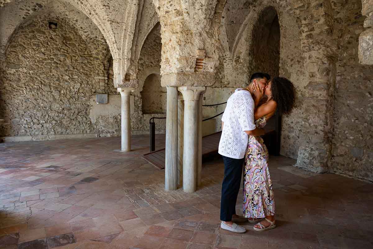 Taking engagement pictures underneath the ancient columns of Villa Rufolo Italy