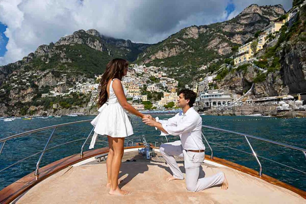 Boat proposal in Positano. Standing on one knee and proposing on the tip of the ship