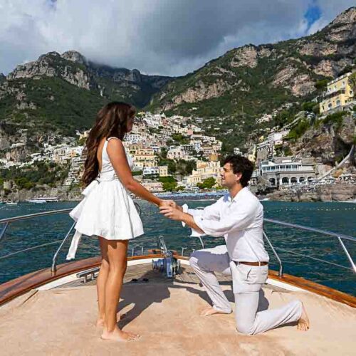 Boat proposal in Positano. Standing on one knee and proposing on the tip of the ship