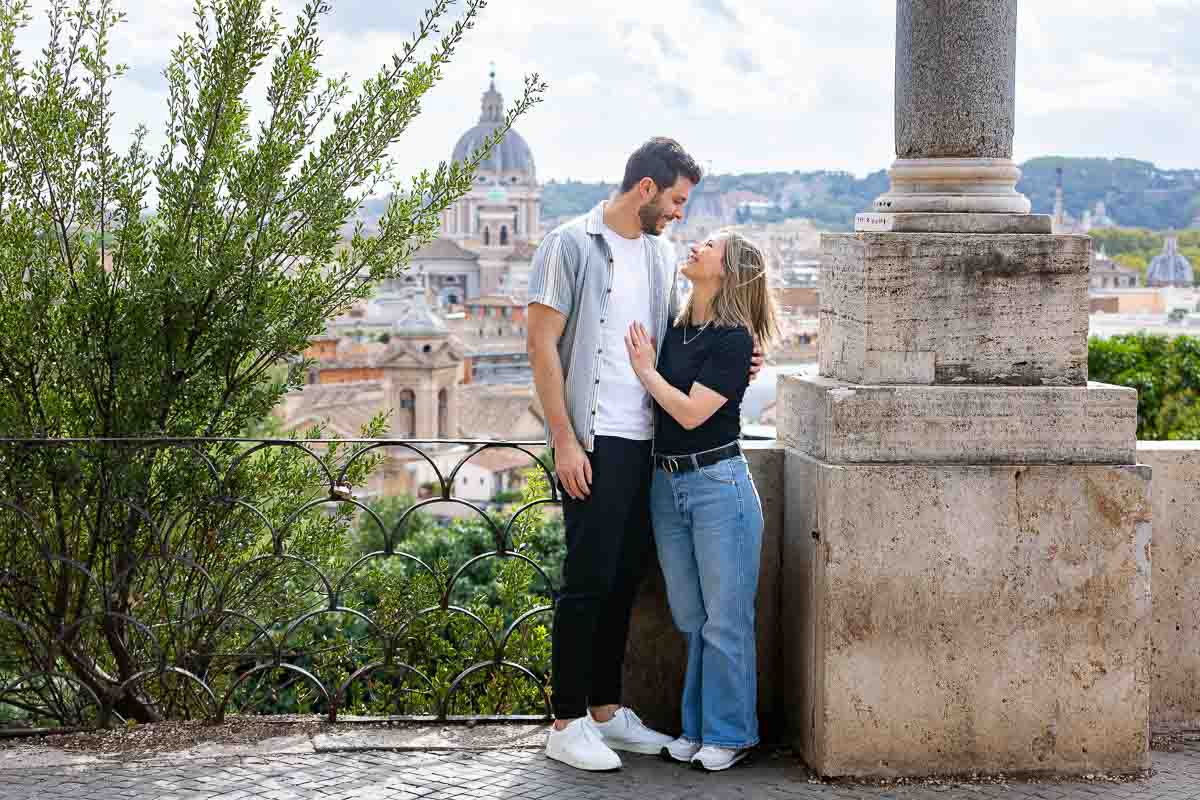 Standing together on a terrace which overlooks the panoramic view of the roman skyline