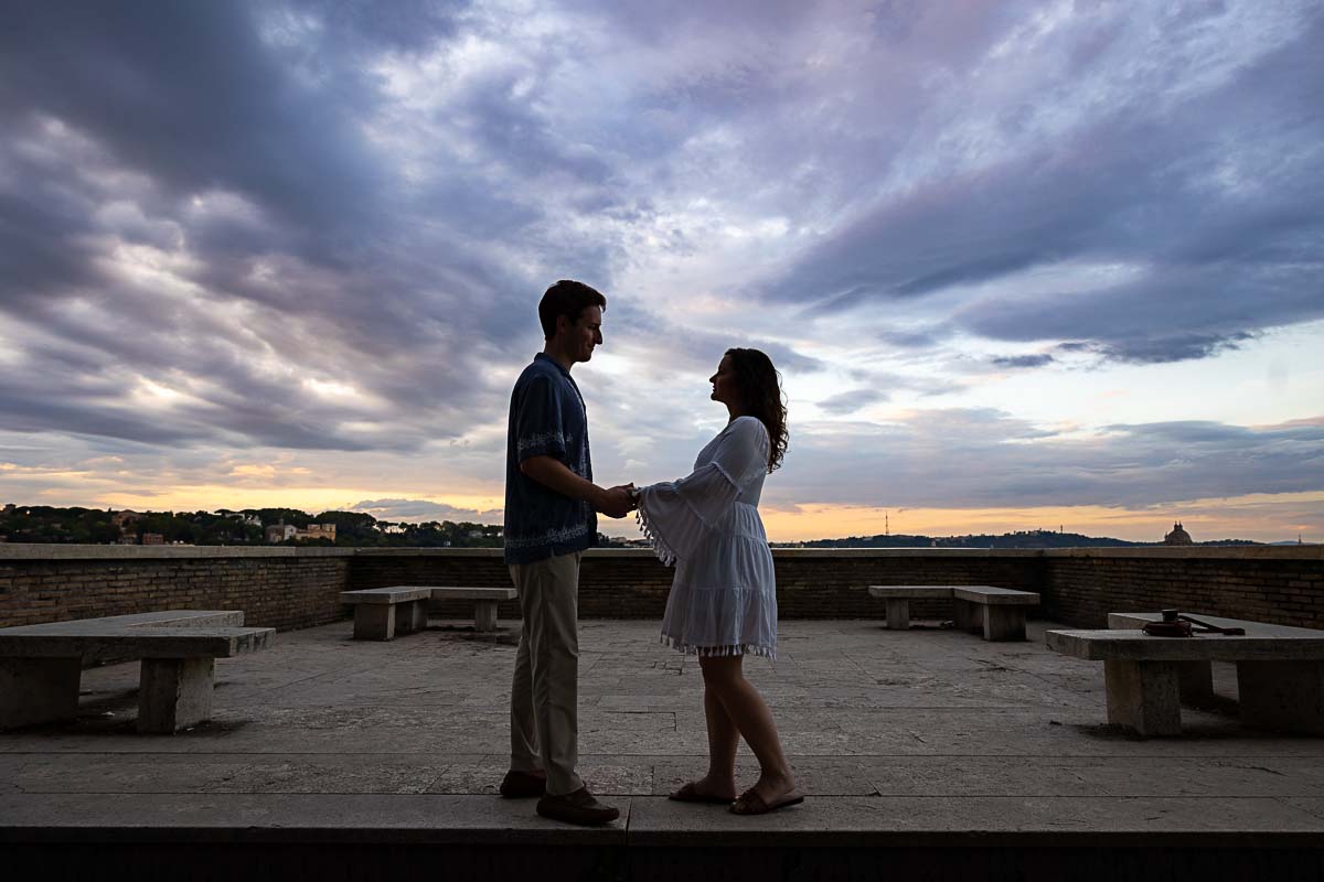 Couple holding hands with the beautiful sun setting sun while taking couple portraits 