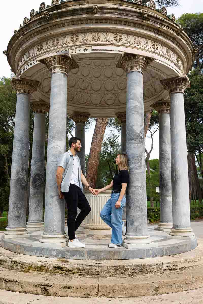 Standing on the Diana Temple steps taking engagement photos in Rome Italy 