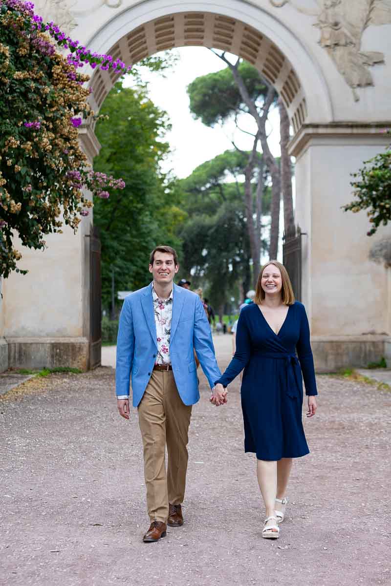 Walking inside the park together holding hands during the engagement photos 