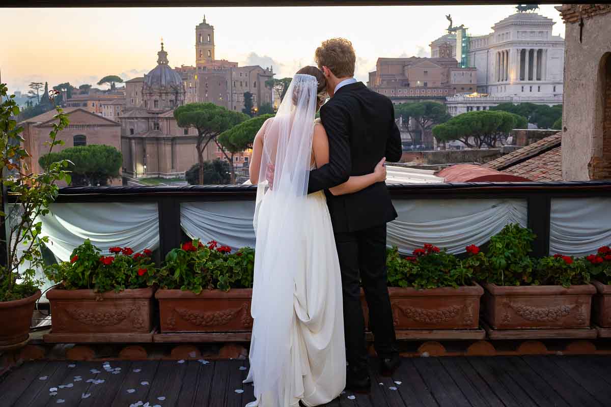 Couple admiring the sunsetting view over the roman skyline. Rome Wedding Photography and Videography