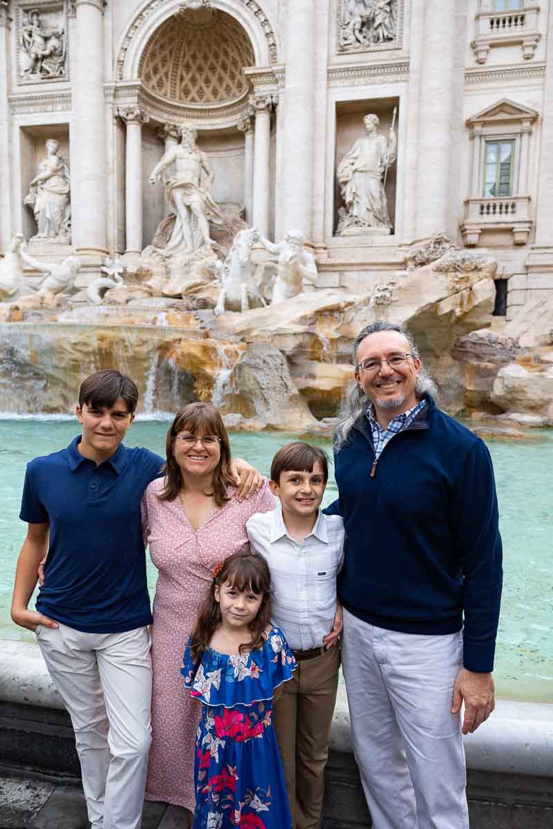 Standing up family portrait taken at the Trevi fountain in Rome Italy