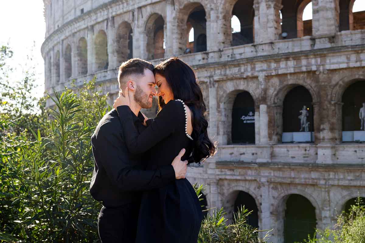 Close up photo of a couple taking pictures at the Coliseum in Rome Italy