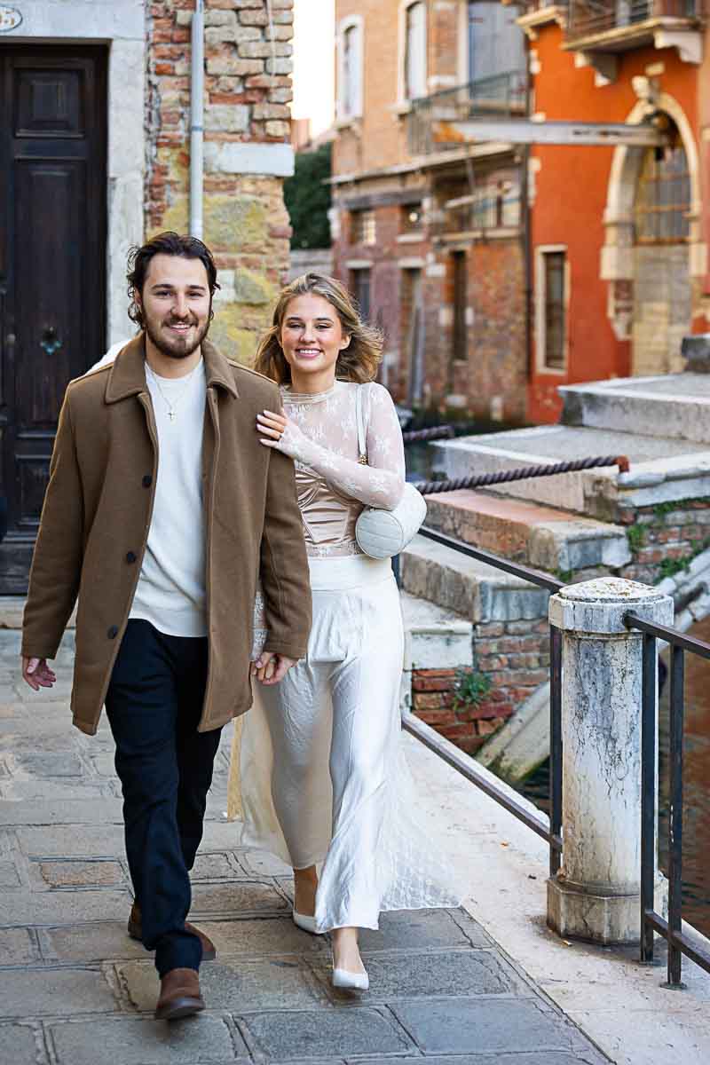 Walking together in love after the marriage proposal in Venice 