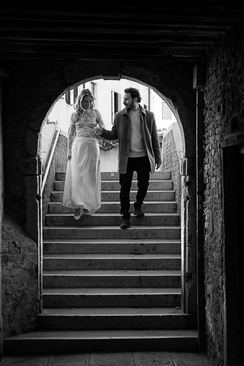 Descending stairs together during a coupe photography session in bw