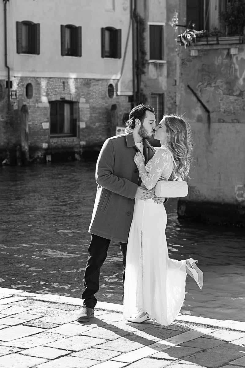 Black and white engagement photos taken by canal water and streets