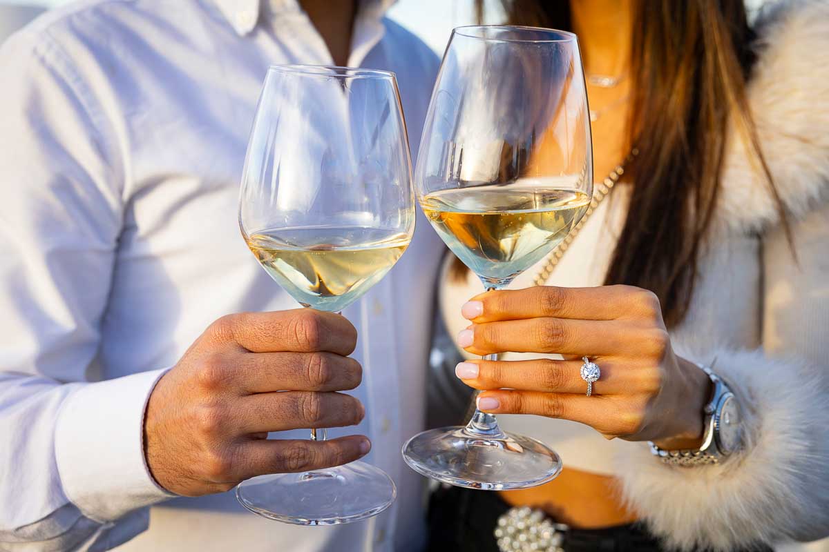 Toasting engagement with champagne and a diamond ring 