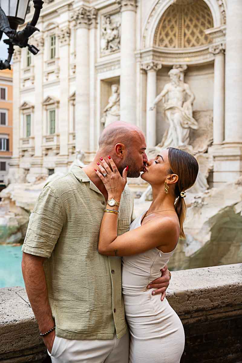 Couple kissing by the Trevi fountain during an Rome Engagement Photo Session