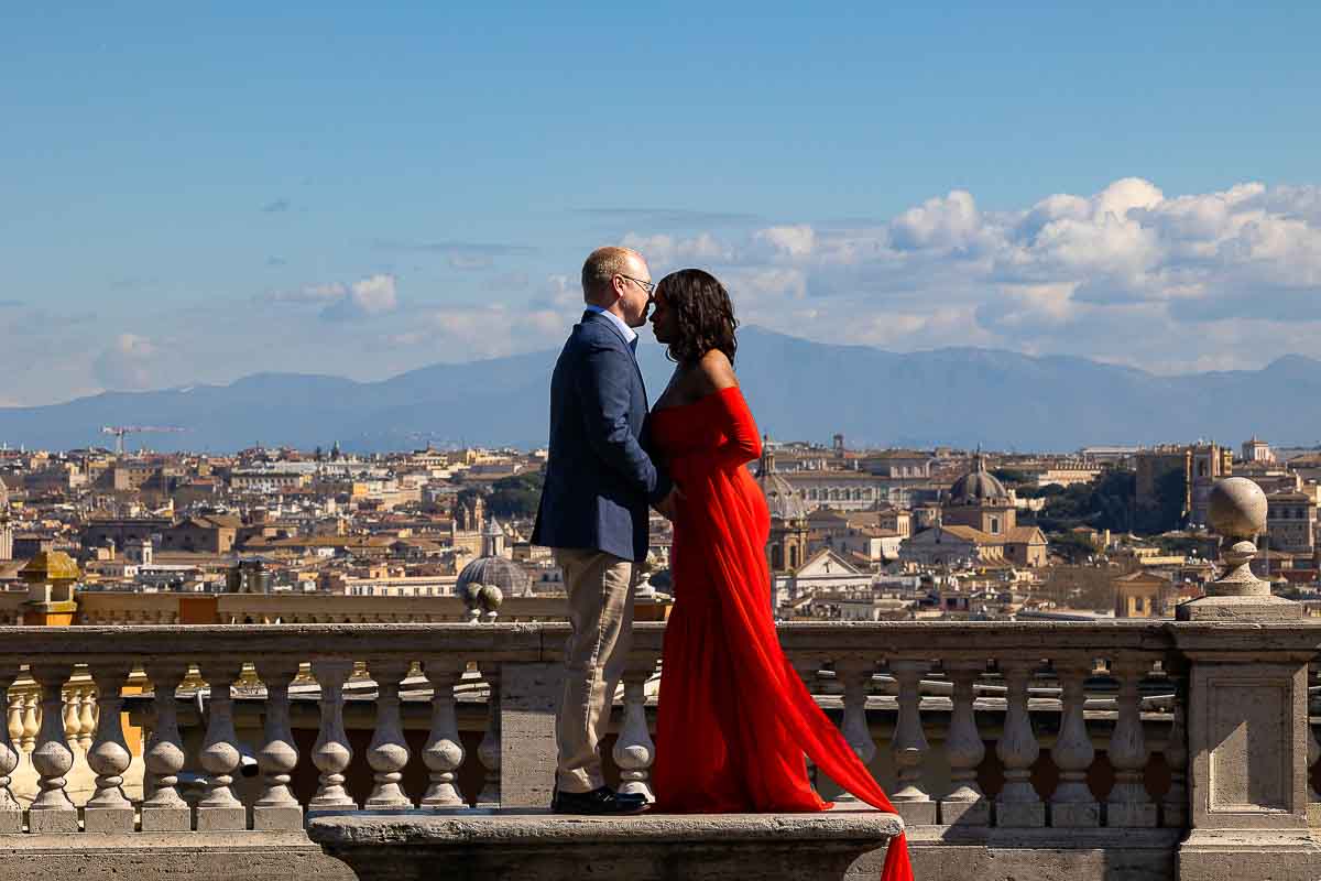 Standing together on a marble bench overlooking the Rome cityscape from the above Janiculum hill photographed by a photographer using a telephoto lens 