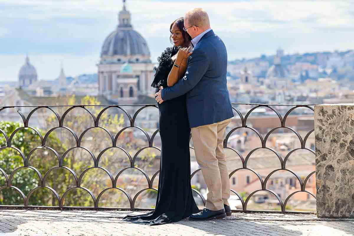 Standing together on the Picio terrace outlook with the city of Rome in the background during a maternity photoshoot in Italy 