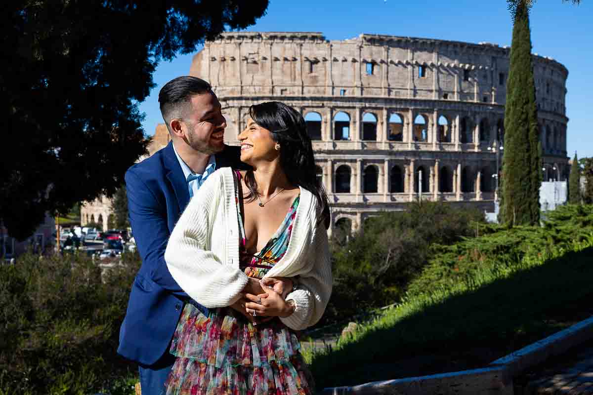 Couple portrait picture taken in front of the Roman Colosseum on a nice bright sunny morning 